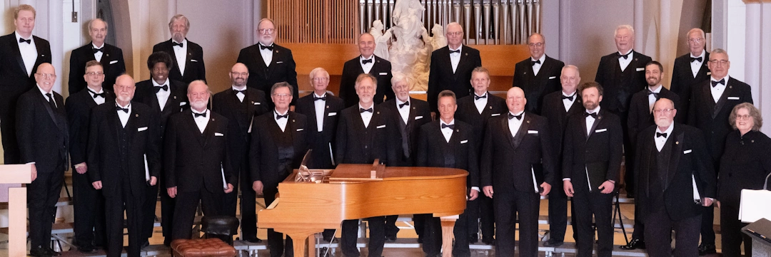 group photo of chiaroscuro men's chorus lined up in performance area
